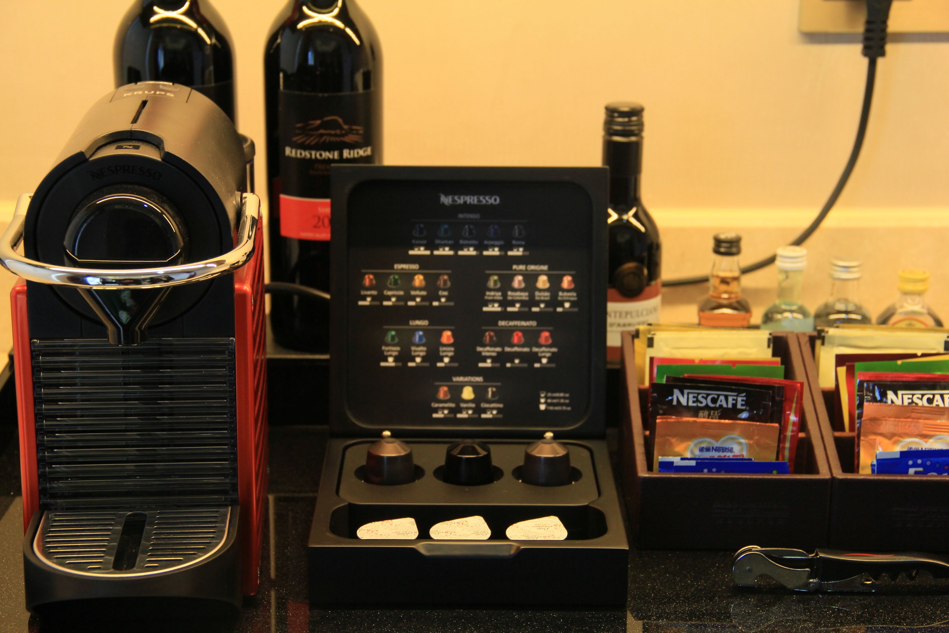 A coffee machine with multiple settings and a coffee pod holder.
