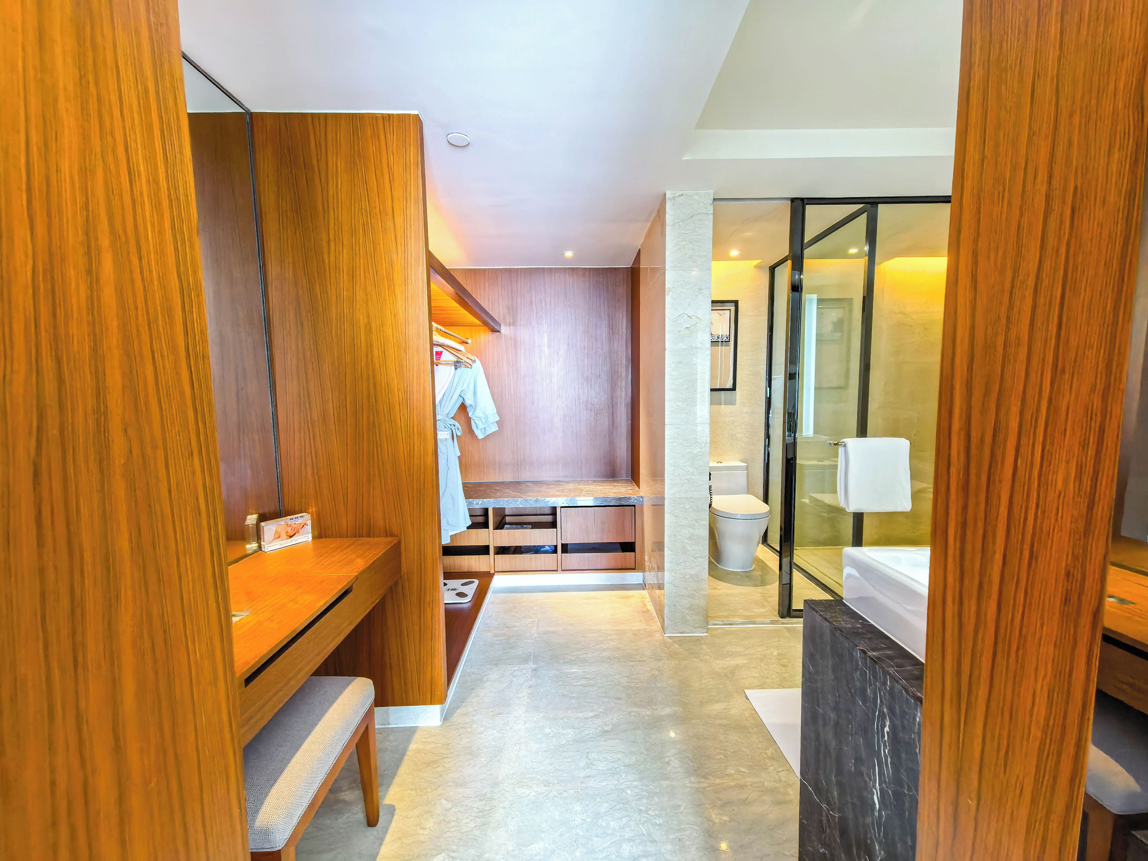 A modern bathroom with a shower, toilet, and vanity.