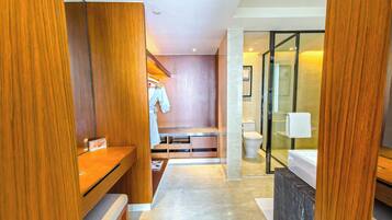 A modern bathroom with a shower, toilet, and vanity.