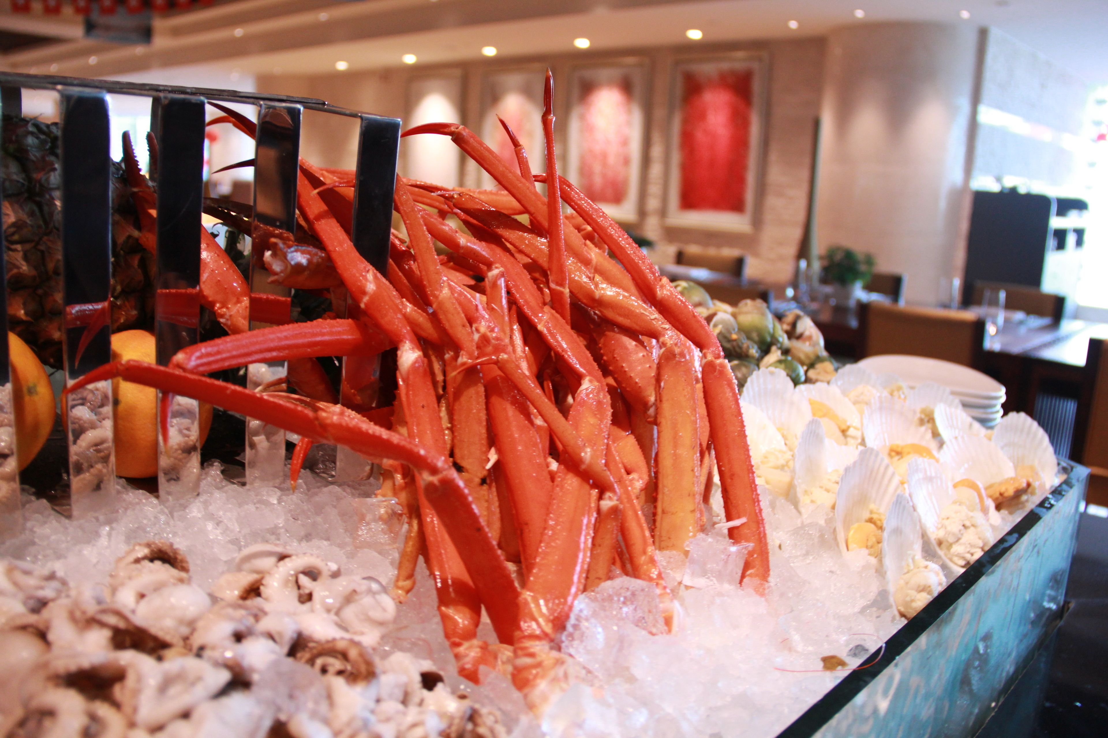 A seafood display with various types of shellfish and lobster on ice.