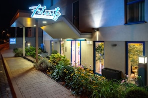 A hotel named 'Felicity' with a modern design, a well-lit entrance, and a landscaped garden area. - Felicity Garni Hotel (Bratislava)