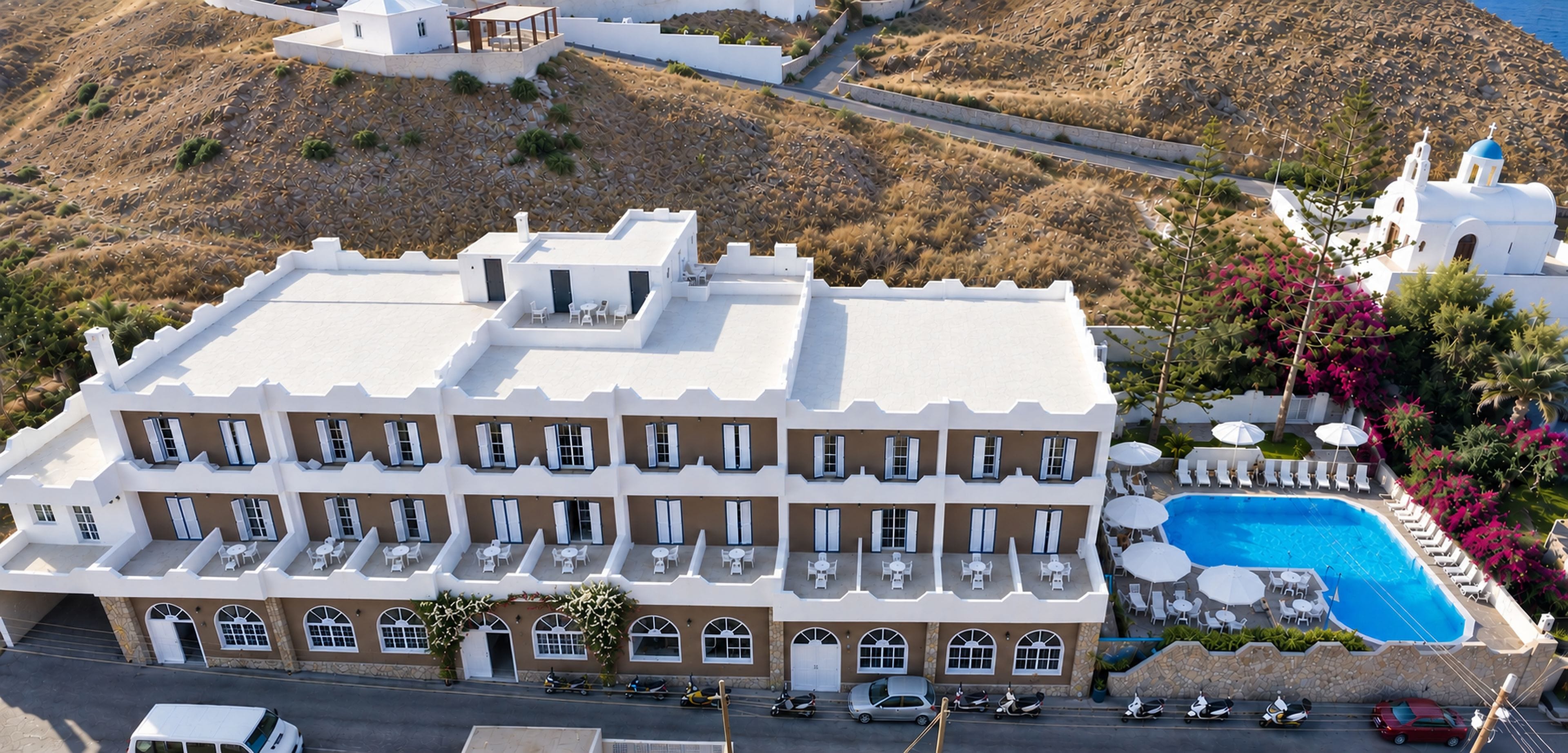 A multi-story hotel with a rooftop pool and outdoor seating.
