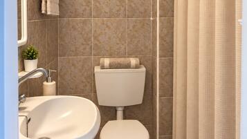 A bathroom with a white sink, toilet, and shower curtain.