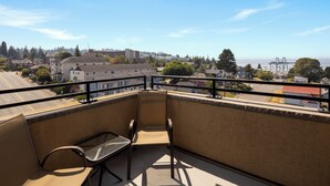 A balcony with a view of a cityscape, including buildings and a bridge. - Hampton Inn Seattle/Everett (Everett)