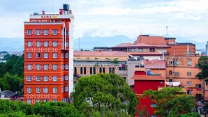 A multi-story building with a red facade and the name "RAMA HOTEL" on the top. - Rama Inn Boutique Home (Kathmandu)