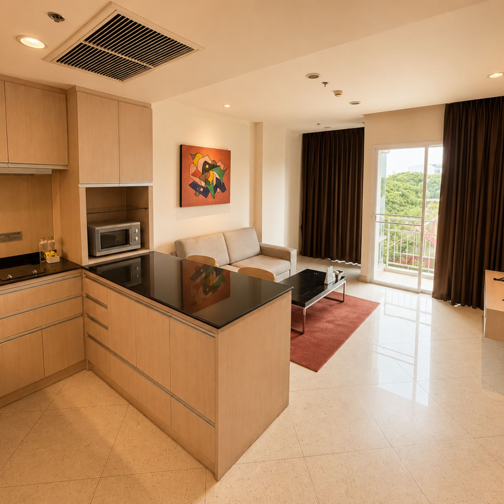 A modern kitchen with a central island, a dining area with a sofa and a coffee table, and a large window with curtains.