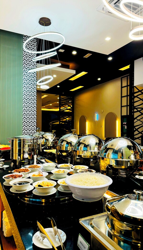 A buffet setup with various food items and a modern interior design.