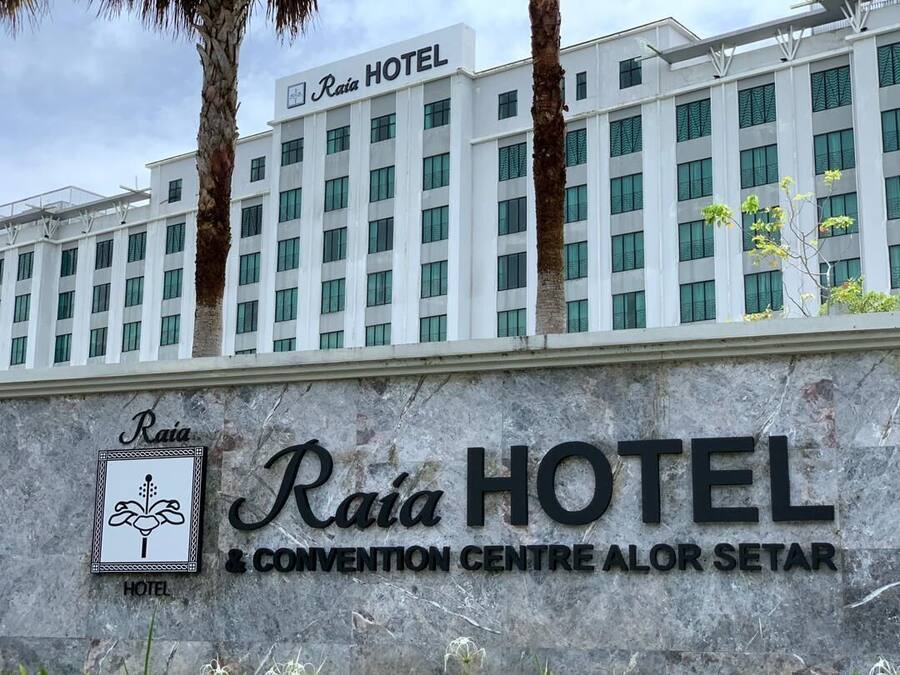 A hotel building with the name "Raia Hotel" and a convention center sign.
