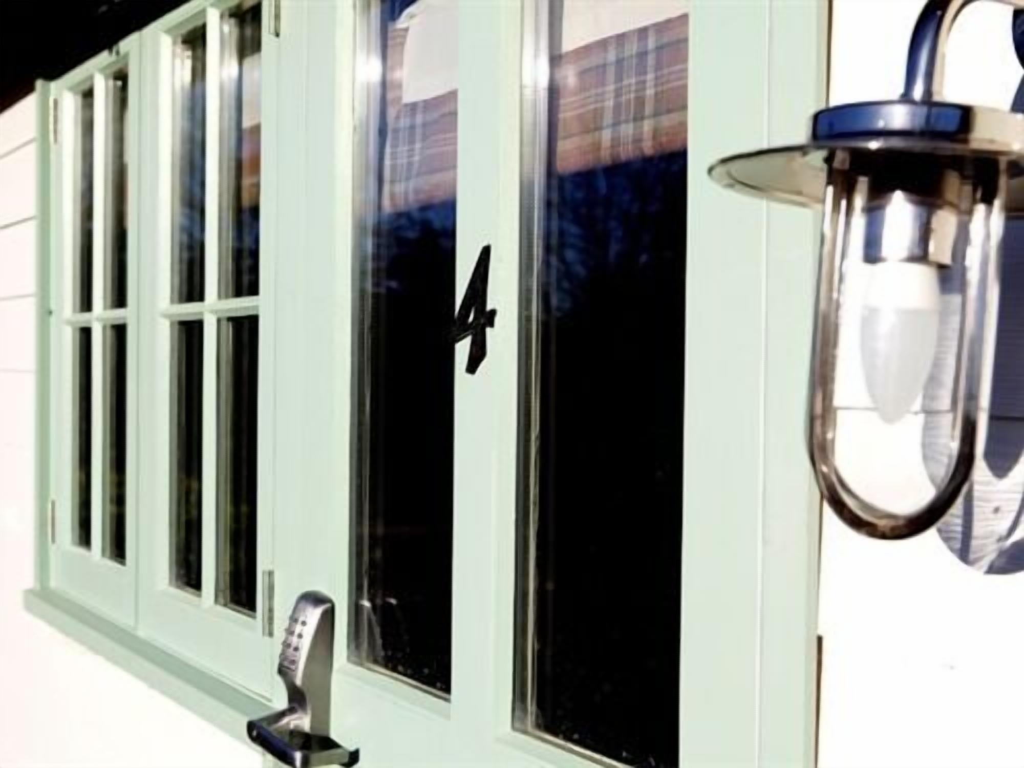 A building with a green door and a number 4 on the window.