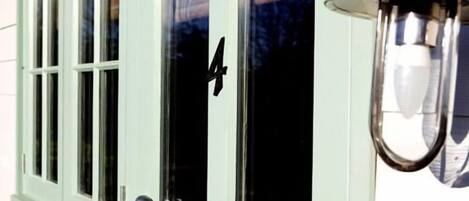 A building with a green door and a number 4 on the window.