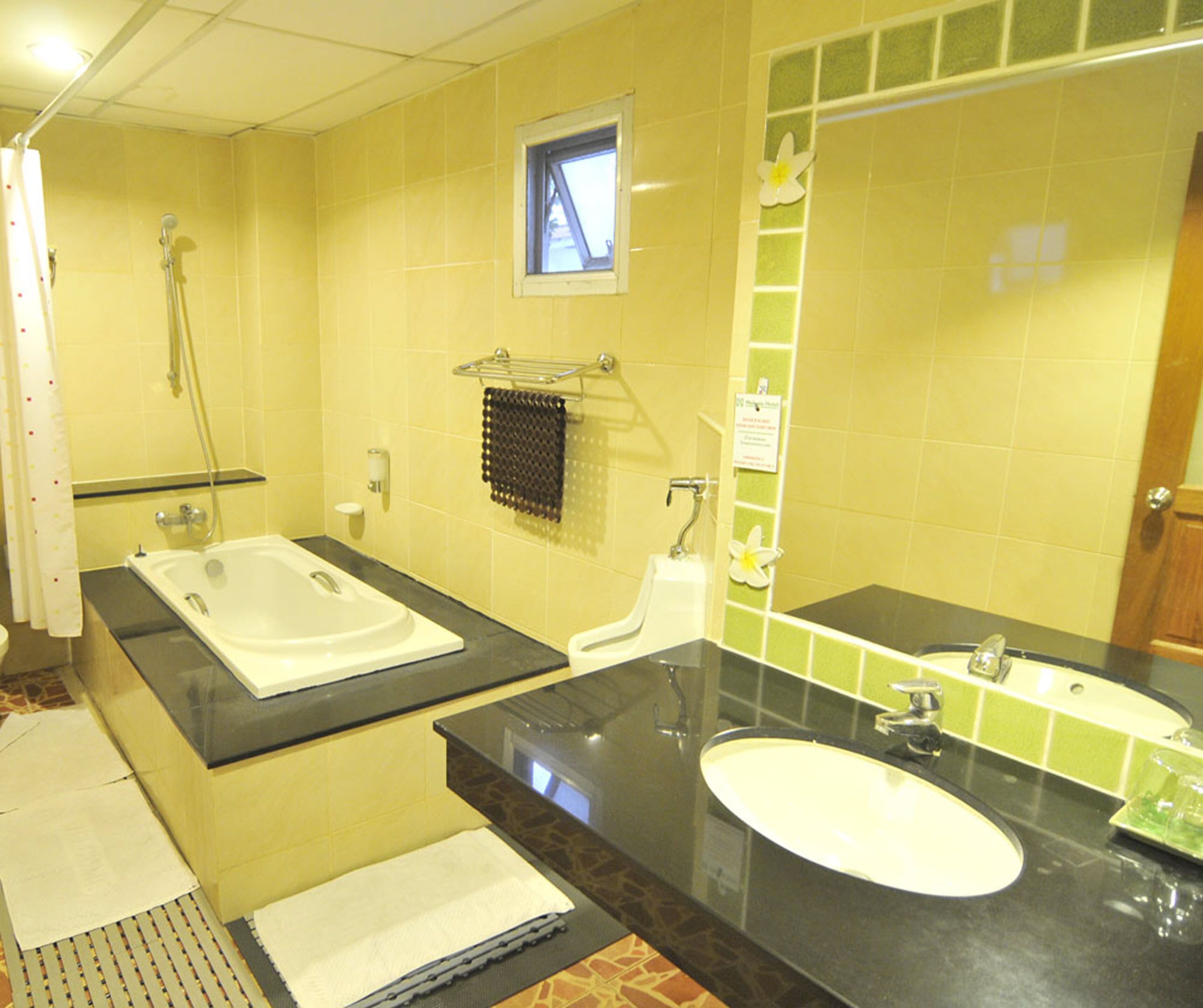 A bathroom with two sinks, a shower, and a towel rack.