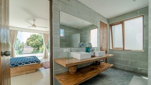 A modern bathroom with a wooden vanity, two sinks, and a large mirror. - Villa Saffira (Seminyak)
