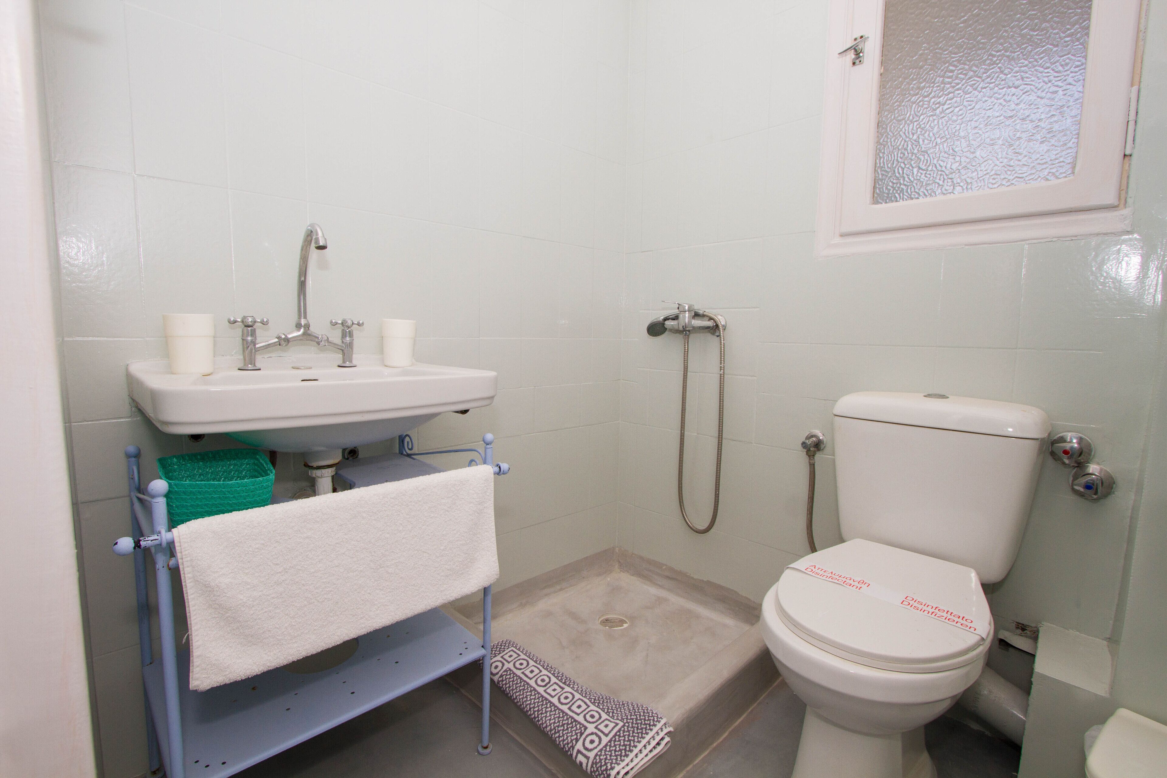 shower, hair dryer, slippers, towels