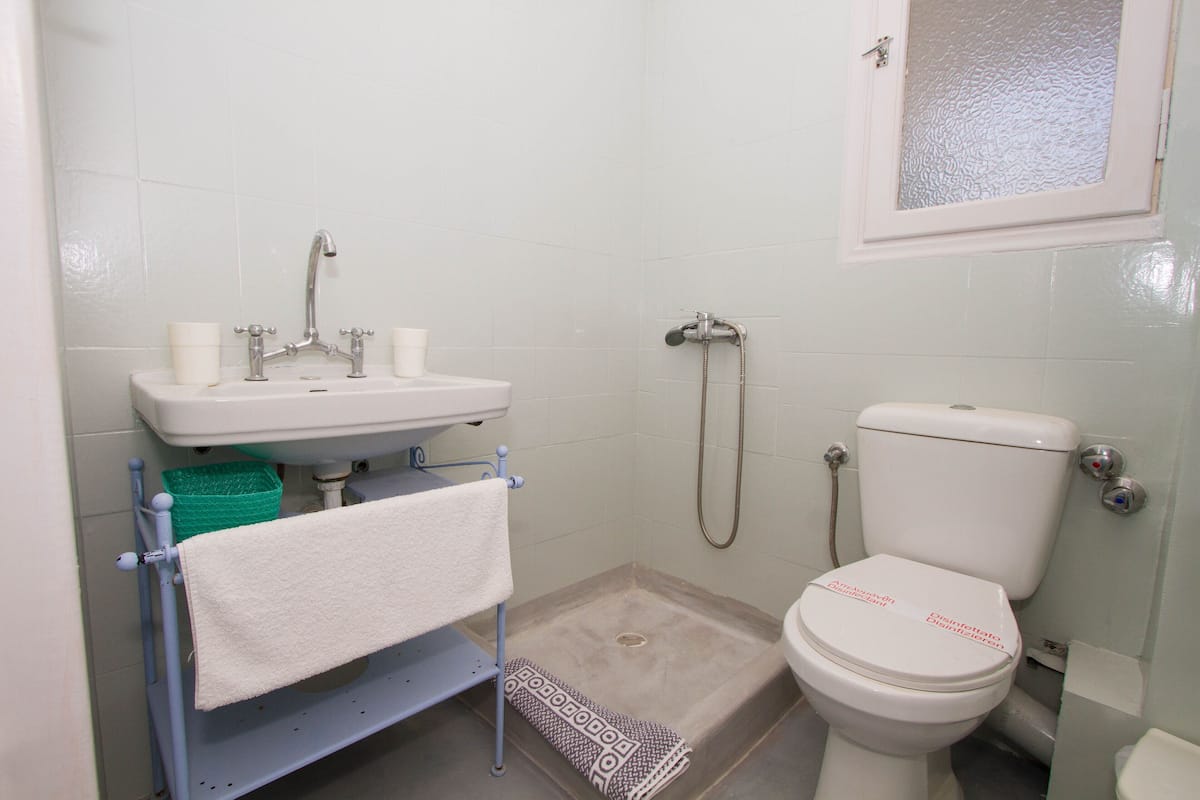 shower, hair dryer, slippers, towels