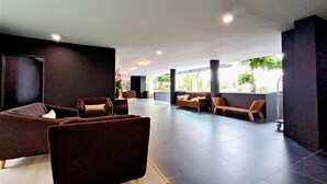 A spacious lobby with modern seating arrangements and large windows offering views of the outdoors. - Raia Inn Penang (George Town)