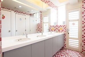 A modern bathroom with three sinks, a mirror, and a tiled floor. - On My Way Taipei Youth Hostel (Taipei)