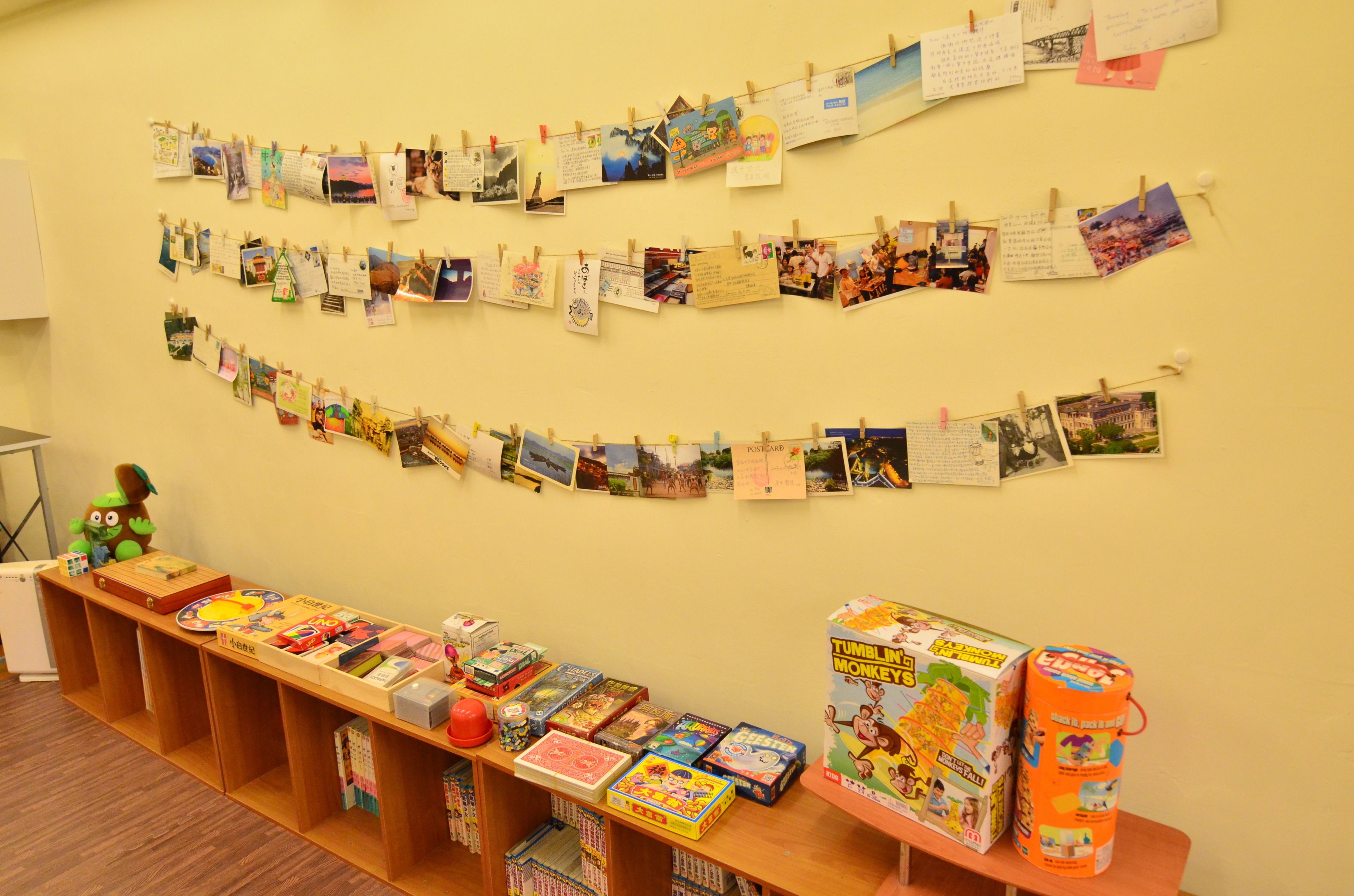 A room with a long table displaying various board games and toys.