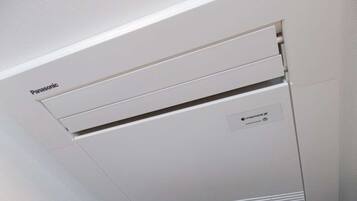 A white Panasonic air conditioning unit with a nanoX label on the side.