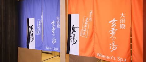 A spa area with separate sections for men's and women's services, indicated by blue and orange curtains respectively.