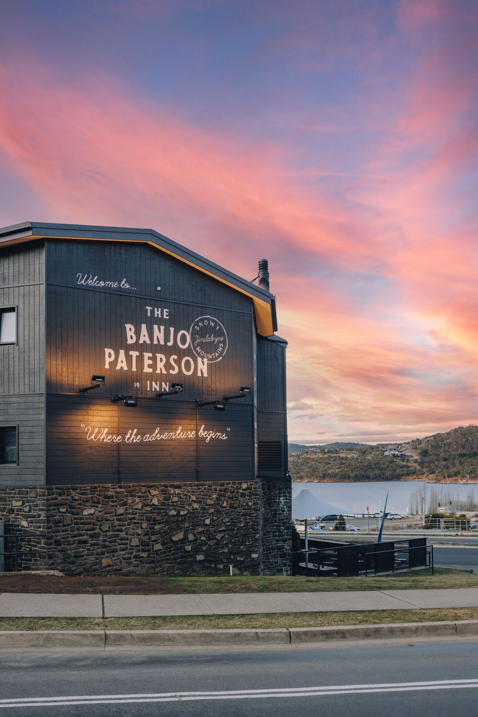 A building with a sign reading "The Banjo Paterson 19 Inn" and a tagline "Where the adventure begins."