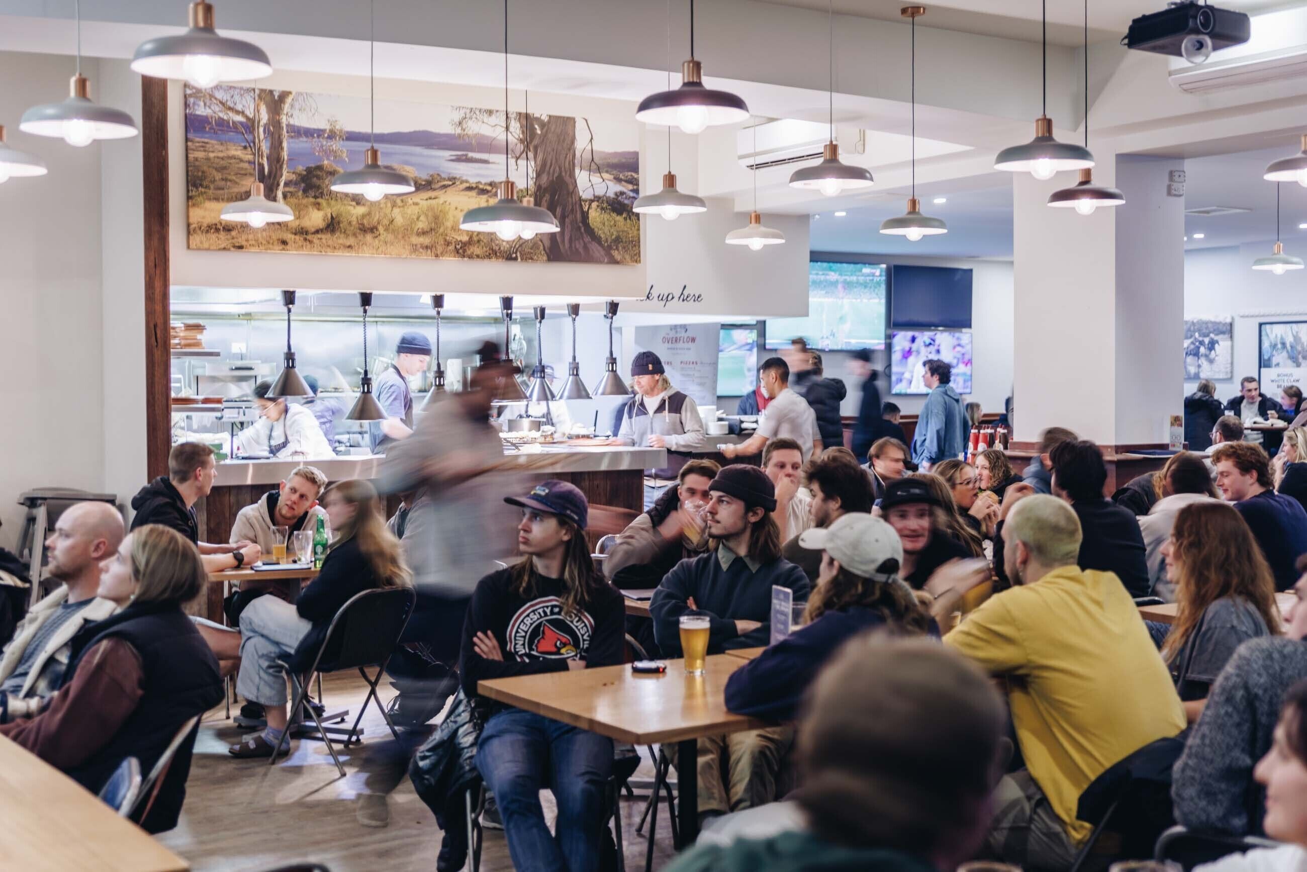 A busy indoor dining area with multiple tables and patrons.