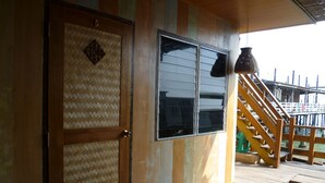 A wooden exterior with a sliding door and a window. - Sukkasem Homestay (Hua Hin)