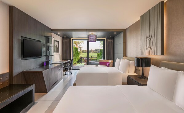 A hotel room with a TV, desk, two beds, a balcony with a view, and a modern design.