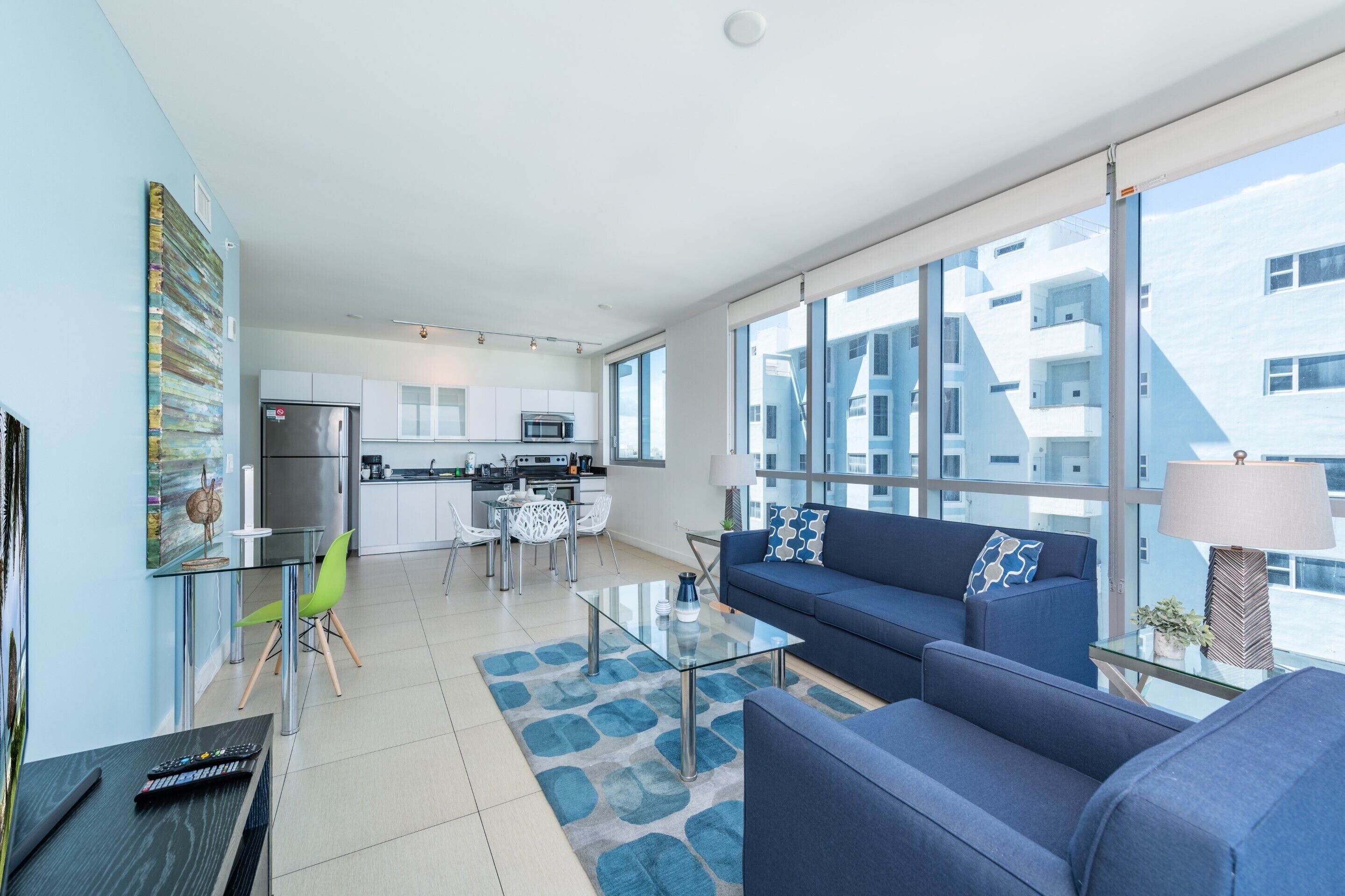 A modern apartment with a living room, kitchen, and dining area.