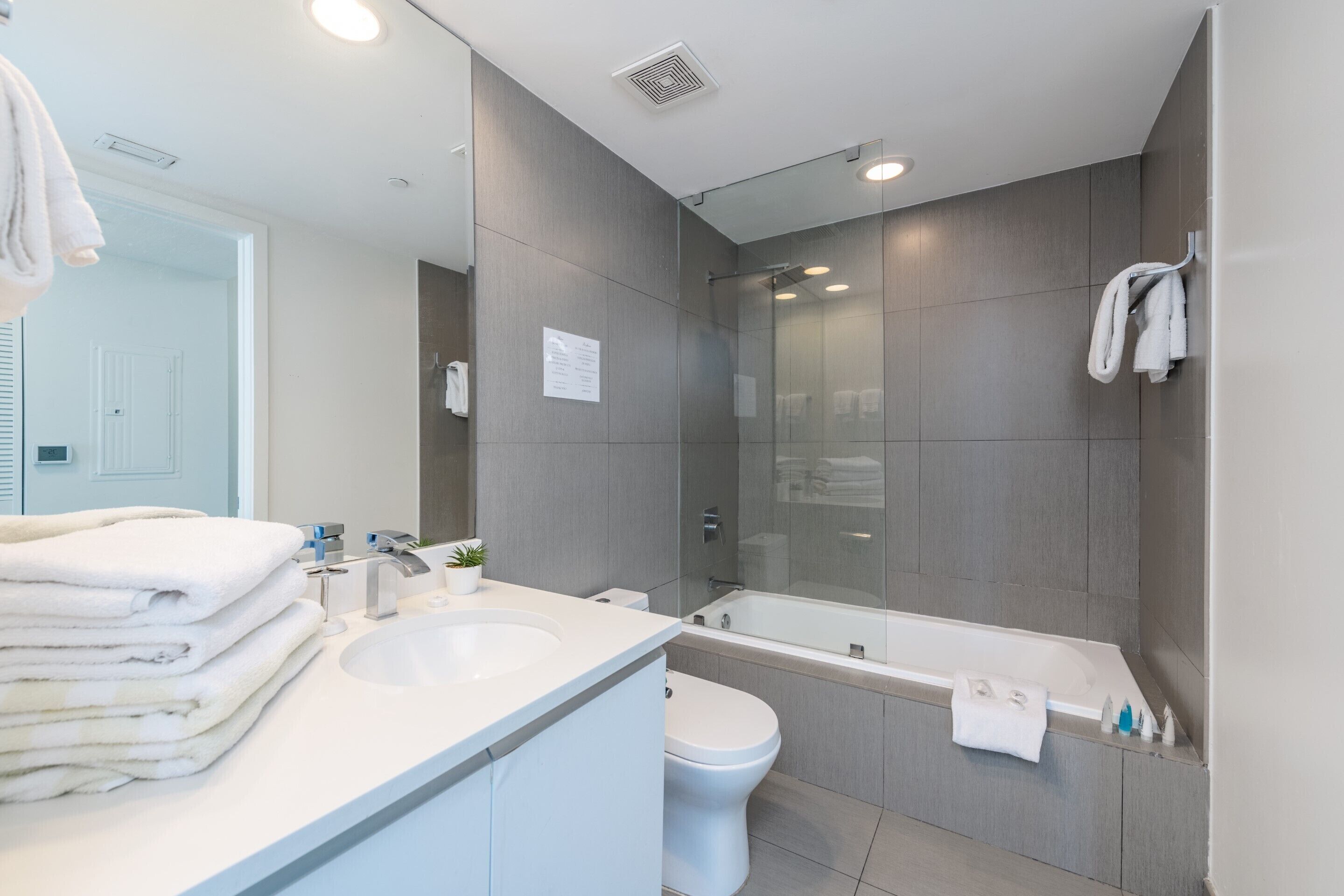 Ein modernes Badezimmer mit Waschbecken, Toilette und Badewanne.