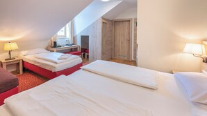 A hotel room with two beds, a desk, and a wardrobe. - Eder  (Munich)