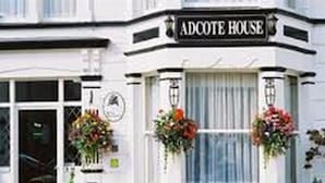 A white building with a sign reading "Adcote House". - Adcote House (Llandudno)
