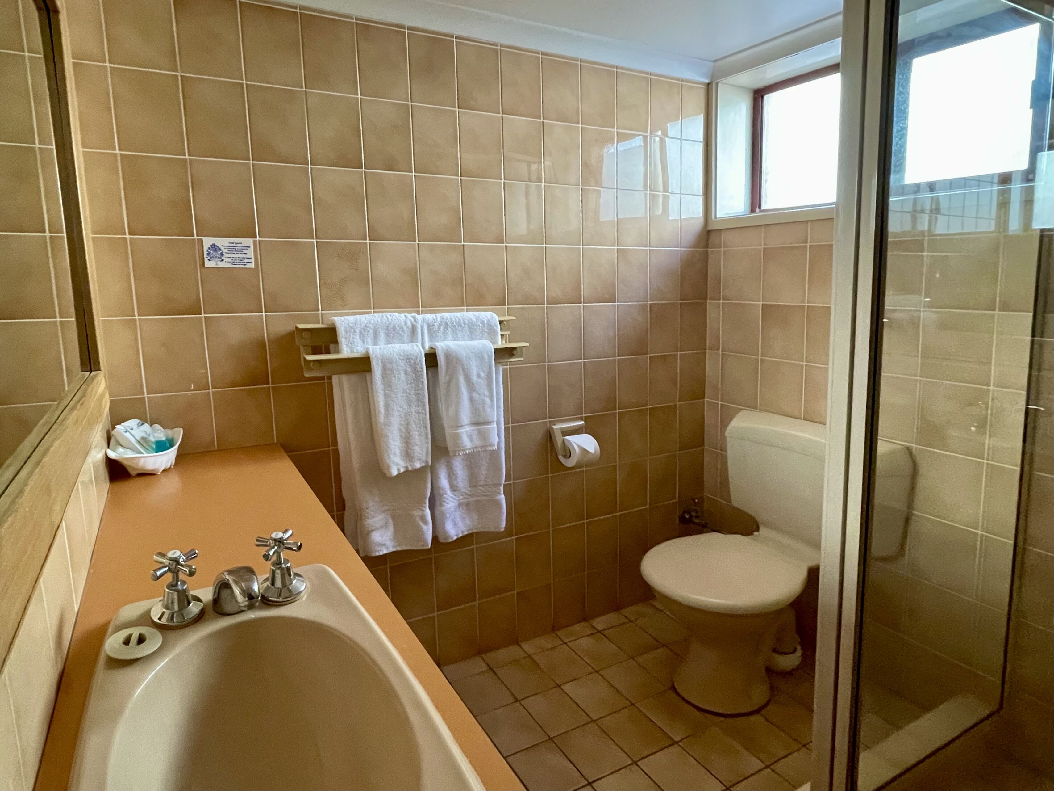 A bathroom with a bathtub, toilet, and shower.