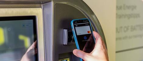 A person using a card reader with a mobile phone.