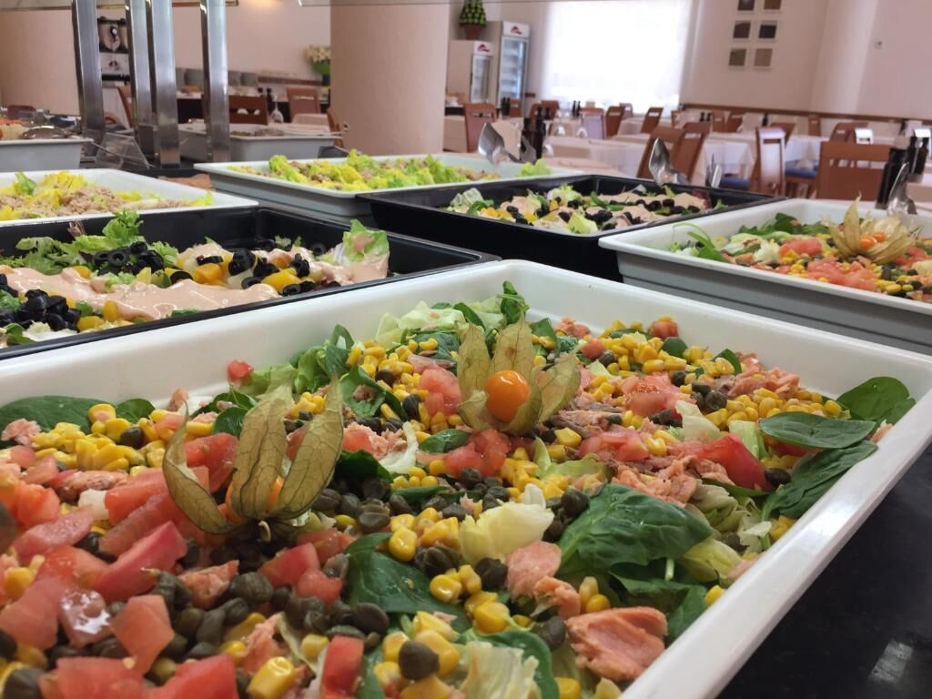 A buffet with various salads and dishes.