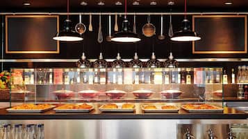 A buffet area with various dishes and condiments.