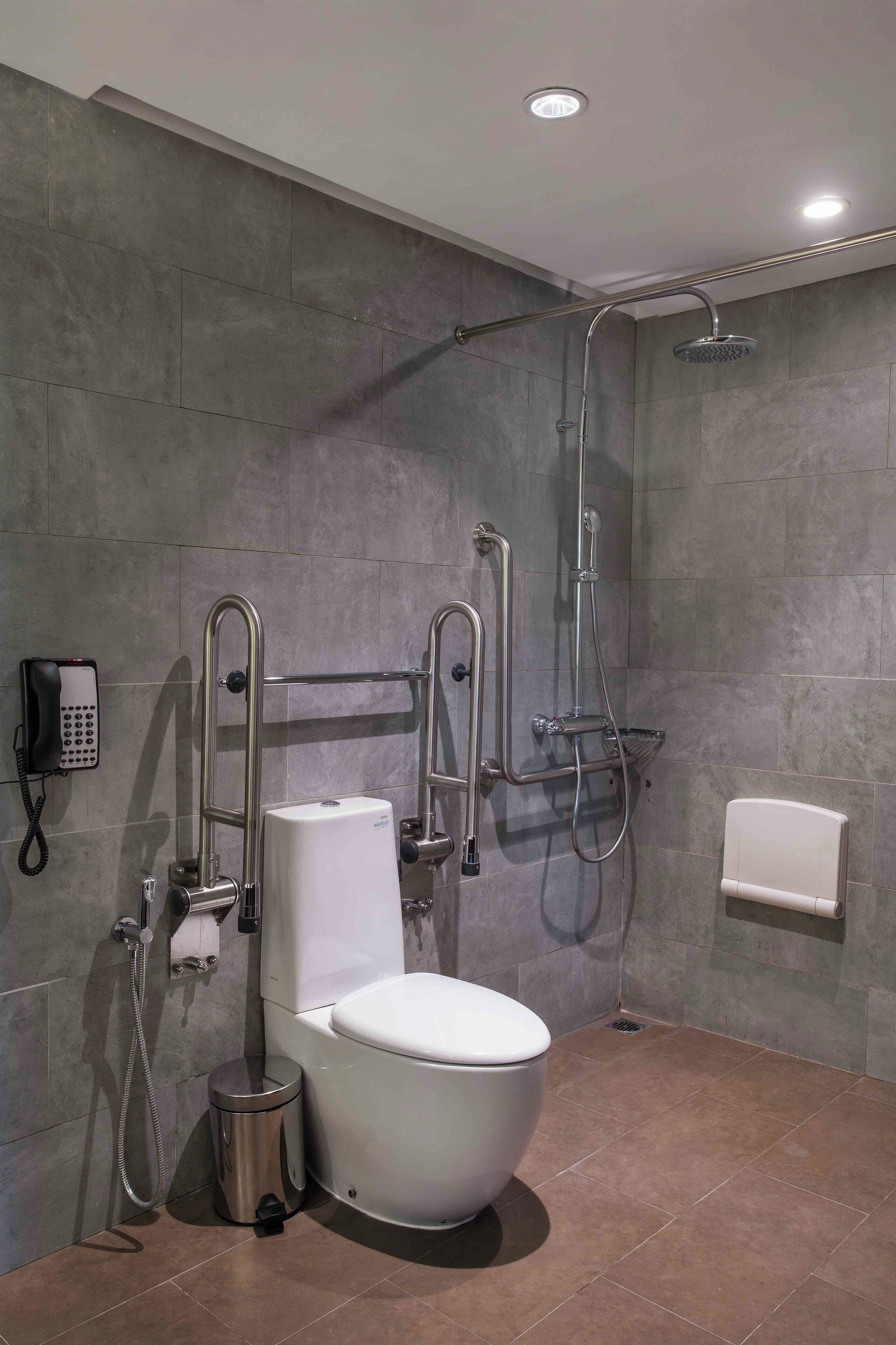 A modern bathroom with a toilet, bidet, and shower.
