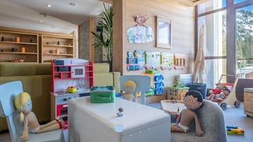 Children can play and learn in this well-organized playroom with a variety of toys and educational materials.