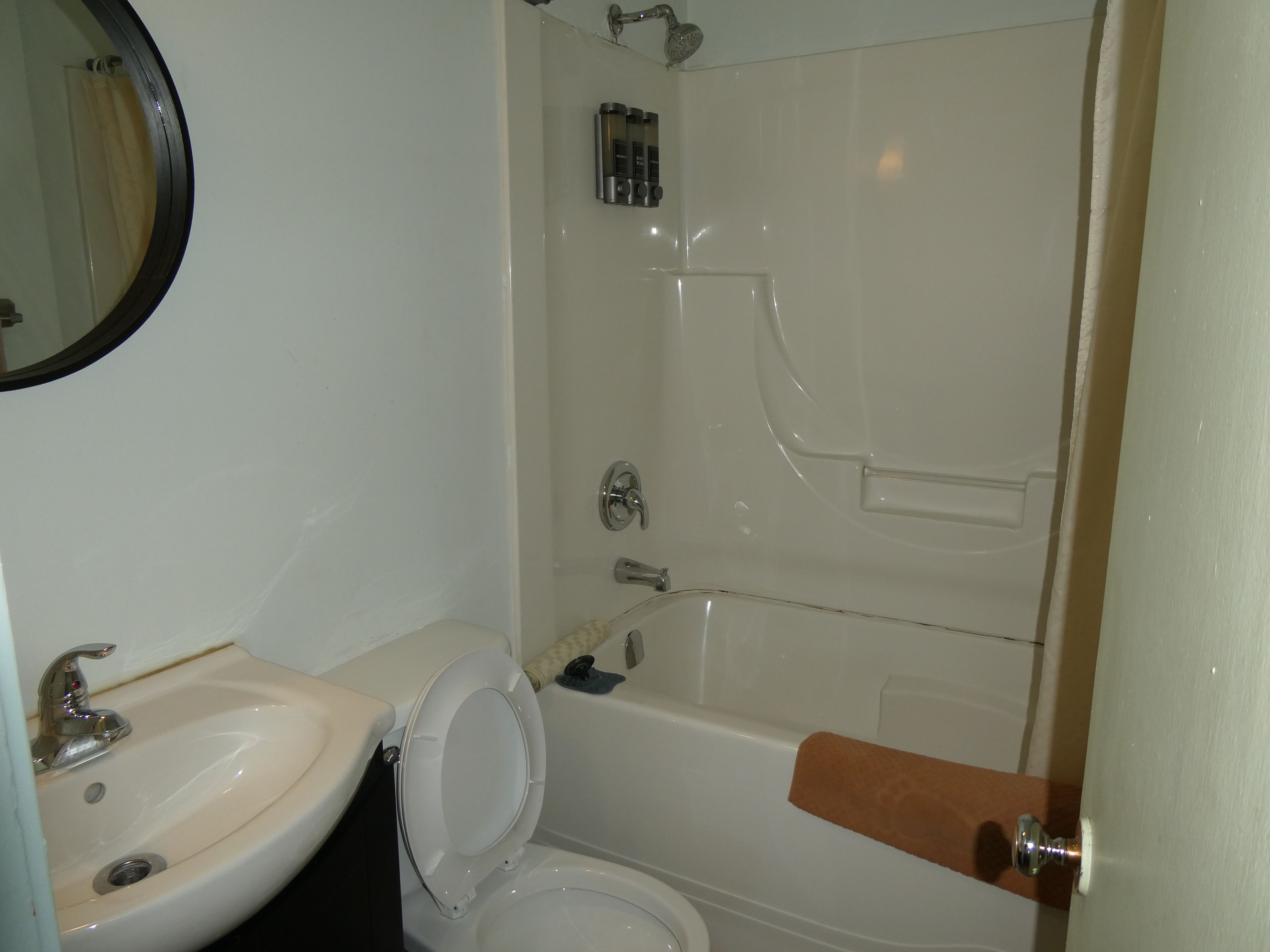 A bathroom with a sink, toilet, and bathtub.