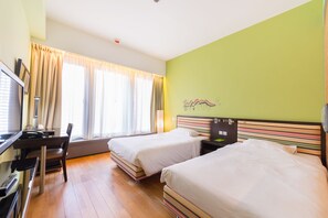 A hotel room with two beds, a desk with a chair, a television, and a window with curtains. - Y Loft Youth Square (Hong Kong)
