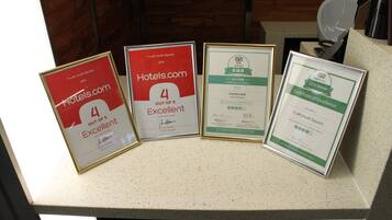Framed awards and certificates on a counter.