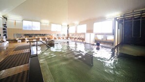An indoor swimming pool with multiple lanes, benches, and a changing room area. - Hotel Pony Onsen (Towada)