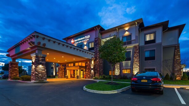A hotel with a modern design, featuring a covered entrance and multiple stories. - Best Western Plus Finger Lakes Inn & Suites (Cortland)