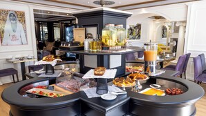 A breakfast buffet with various food items and beverages.