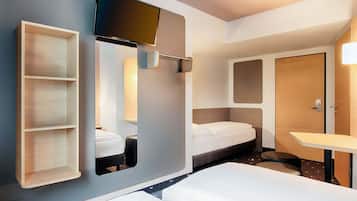 Una camera d'albergo moderna con un letto, una TV a muro, una piccola scrivania e un armadio.