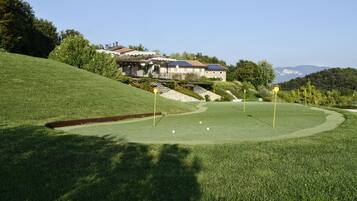 Golfers can enjoy a serene round on the well-maintained course with a clear view of the clubhouse.
