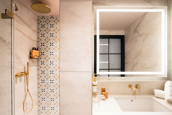 A modern bathroom with a shower, a bathtub, and a large mirror.