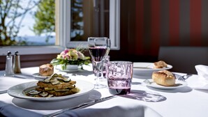 A table set for a meal with plates of food, glasses, and cutlery. - Domaine Lyon Saint Joseph (Francheville)