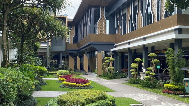 A modern building with a courtyard featuring manicured gardens and a central pathway. - Griya Persada Convention Hotel & Resort Kaliurang (Pakem)