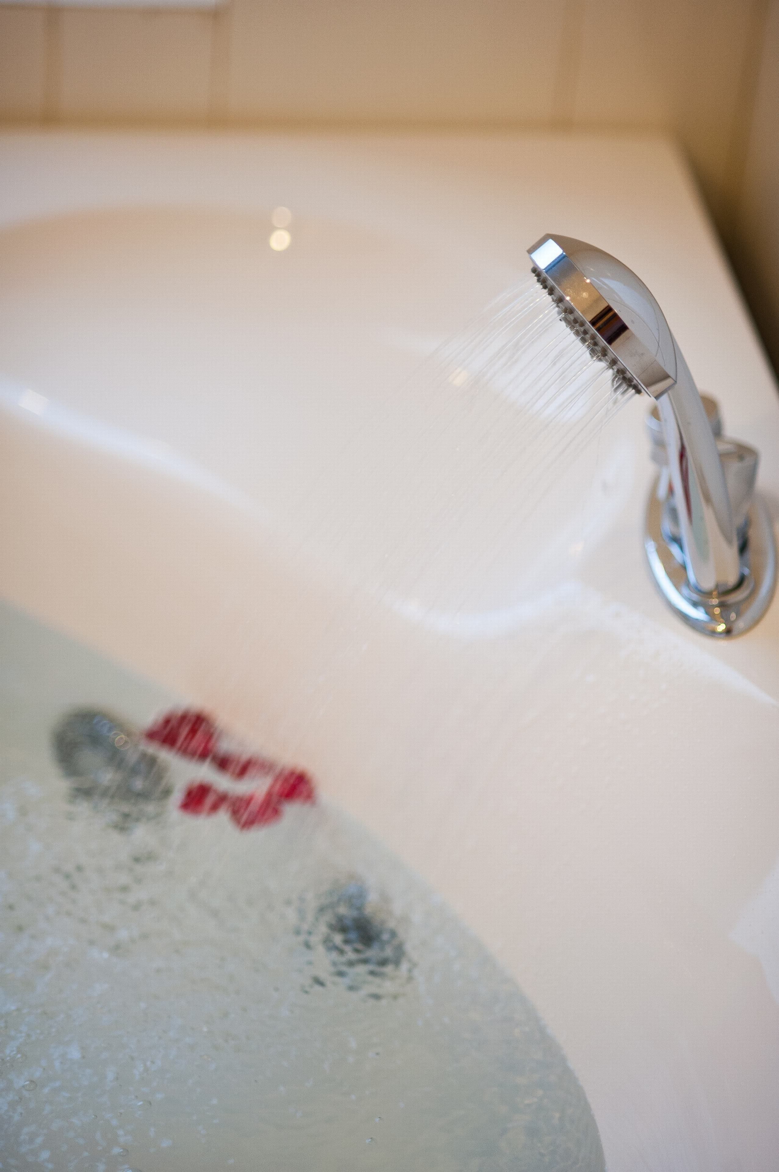 A bathroom sink with running water and a faucet.