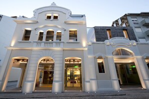 A historic building with arched windows and a central entrance.